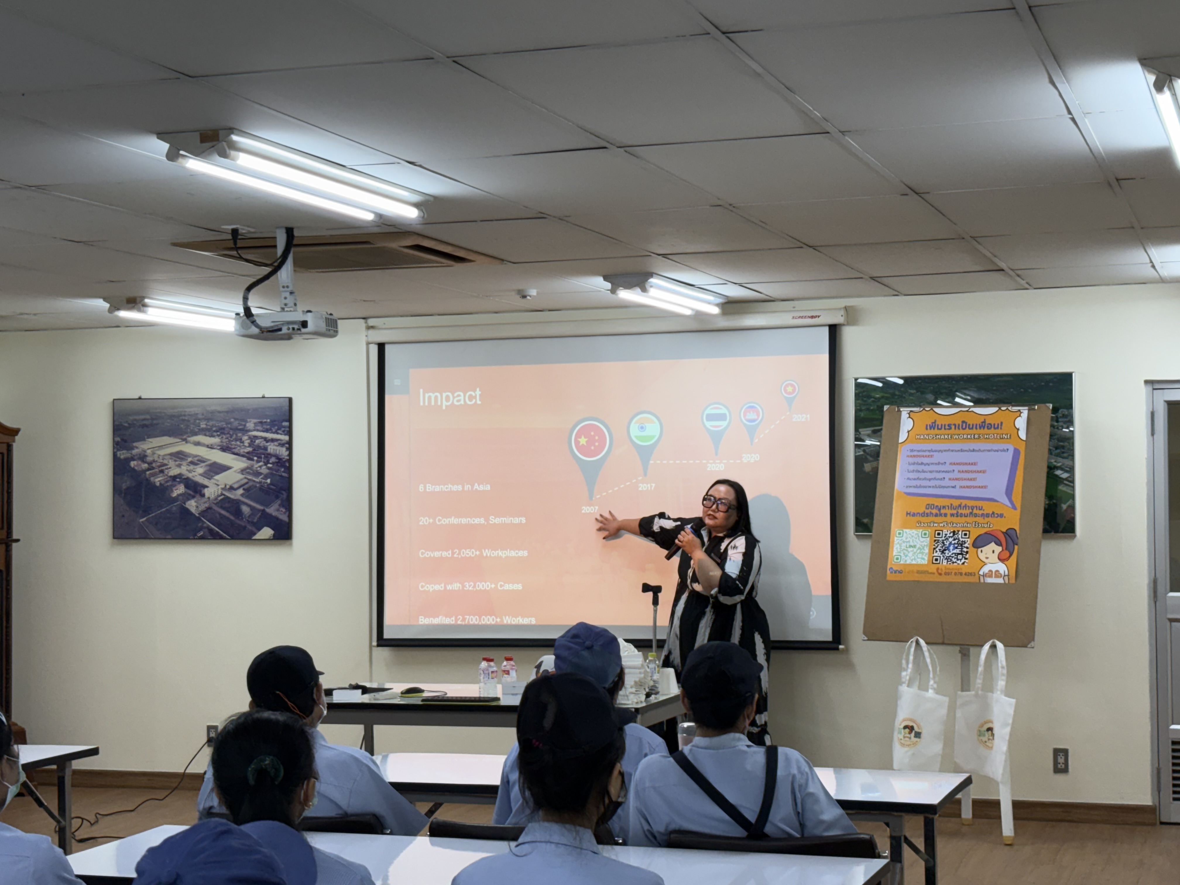 A facilitator speaking with workers in a workplace rights session